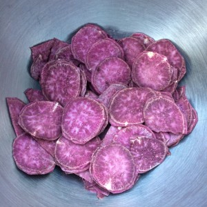 Sliced purple sweet potatoes waiting for the frying pan.